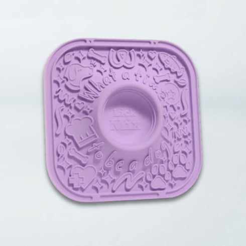 A lavender purple silicone mold with a central circular cavity and embossed doodle-style graphics, shown on a plain white background.